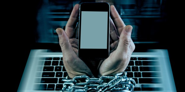 work addict business man locked enchained in mobile phone addiction